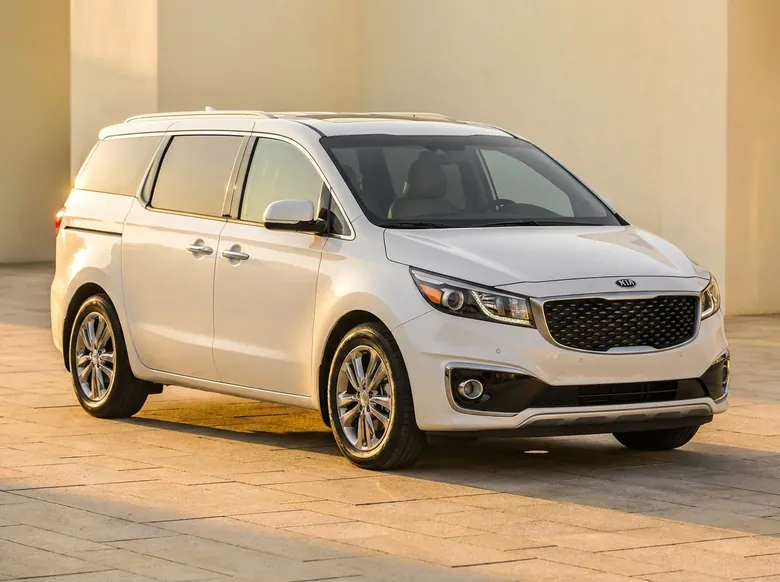 Pearl-white Kia Carnival eight-seat MPV